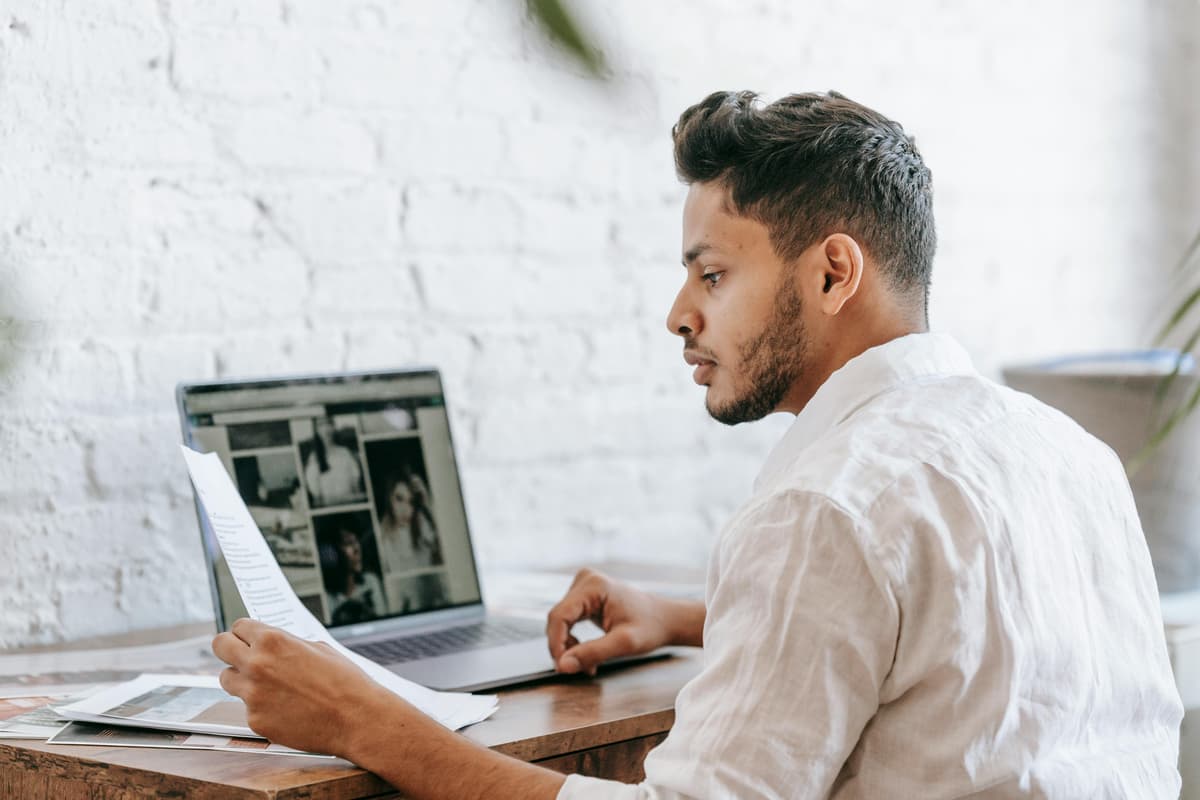 Focused male reading document, representing the analysis of SEO data