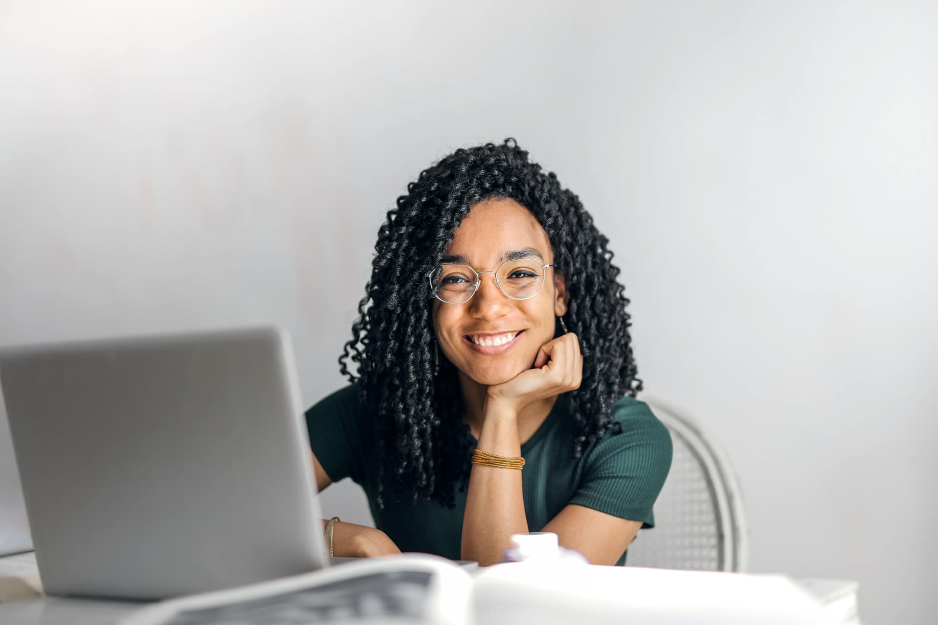 Happy woman using laptop, representing successful blog theme selection