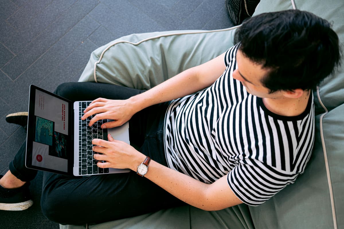 Man using laptop, representing the decision-making process for choosing a WordPress blog platform