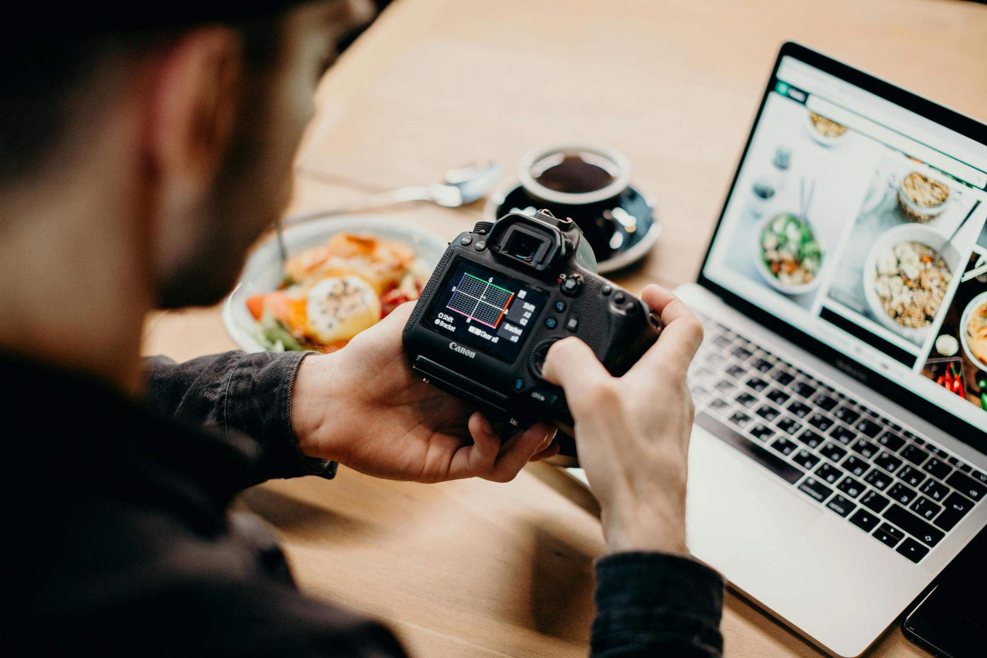 Man holding a DSLR camera, representing content creation for blogs