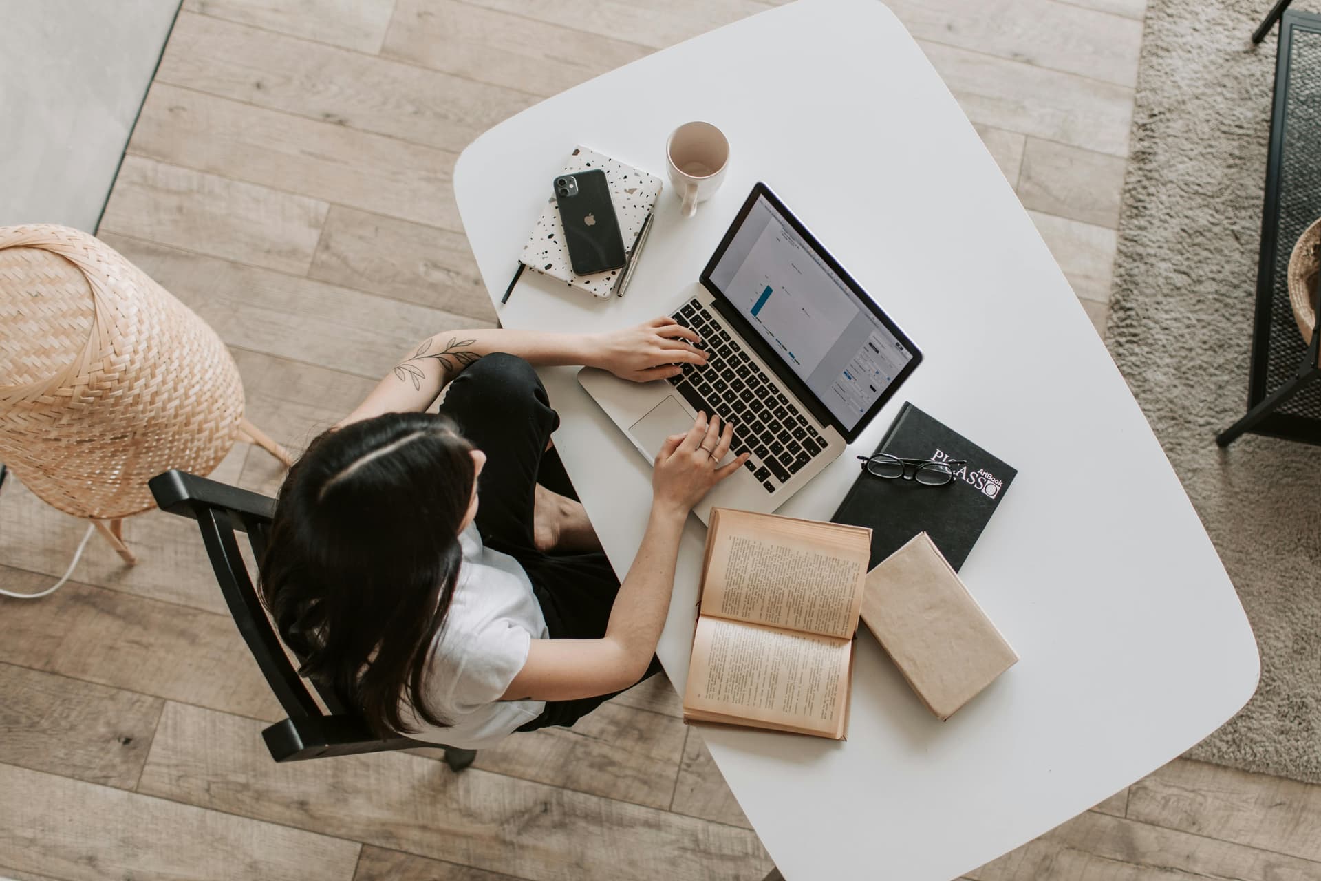 Person typing on laptop in a cozy living room, representing Squarespace SEO optimization