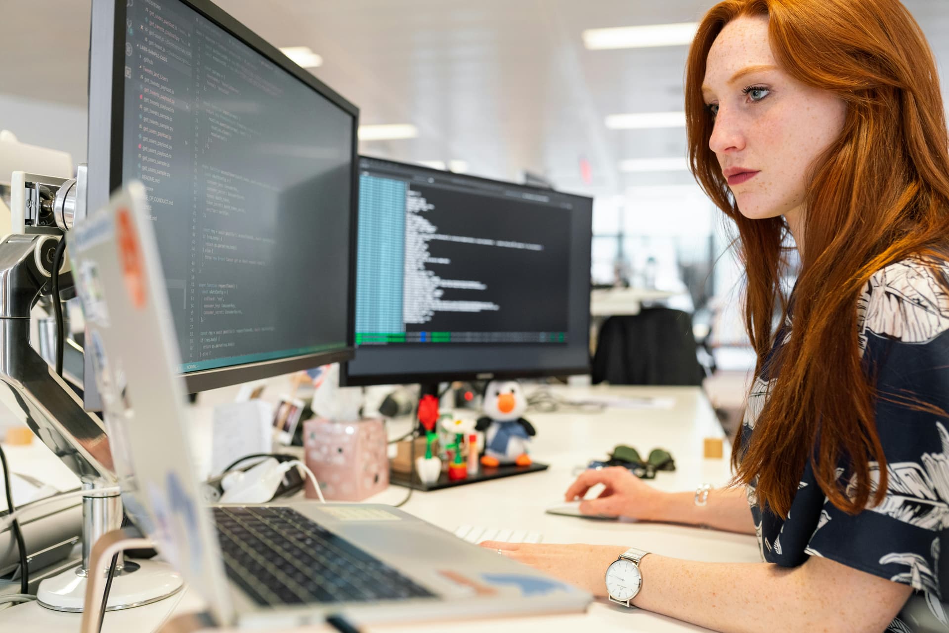 Woman coding on a computer, representing SEO automation tools for WordPress